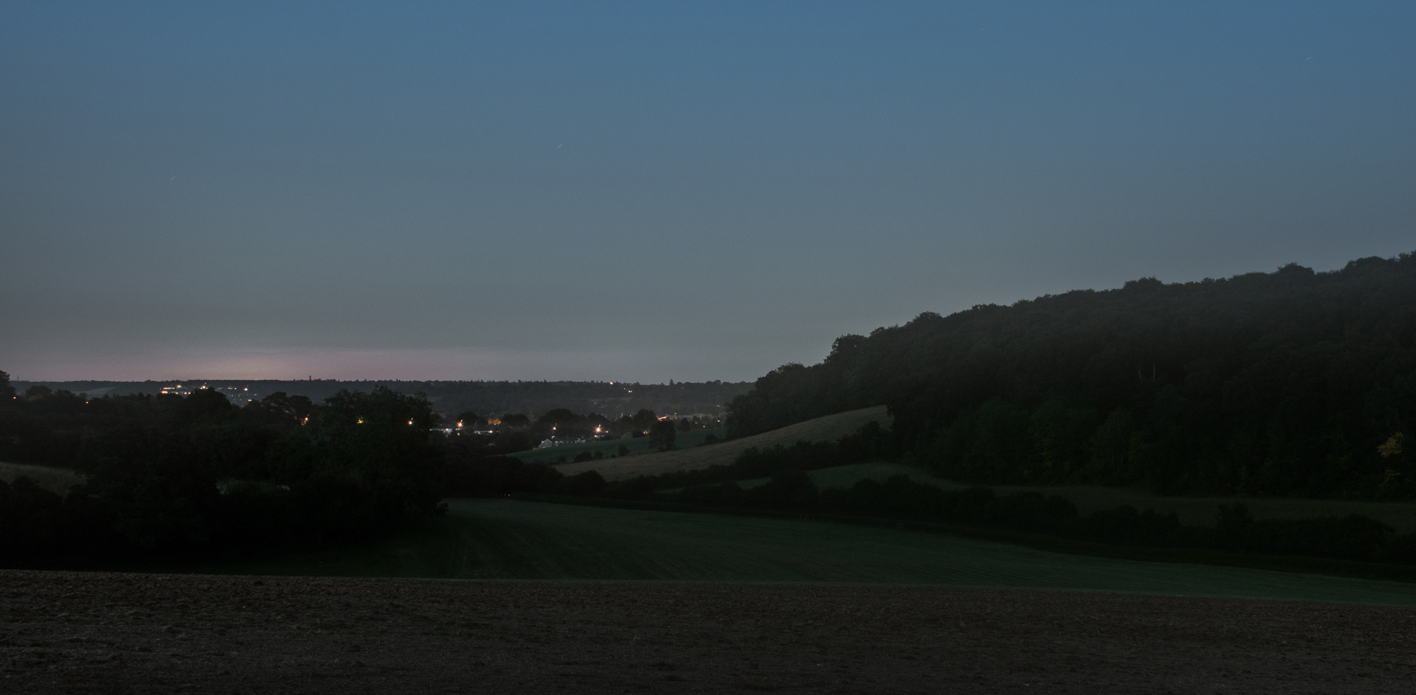 night time landscape with town in distance